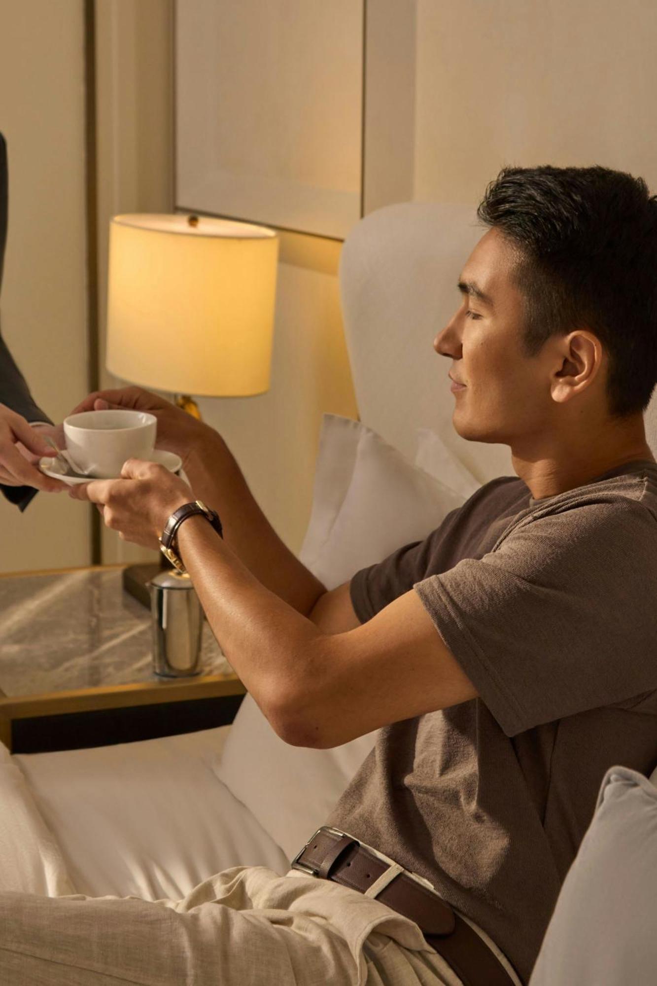 The St. Regis Astana Hotel Bagian luar foto A guest being served coffee